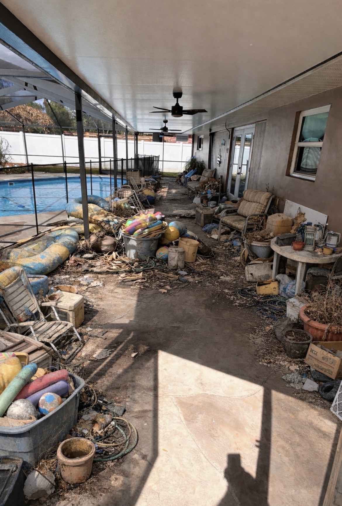 Cluttered patio before junk removal