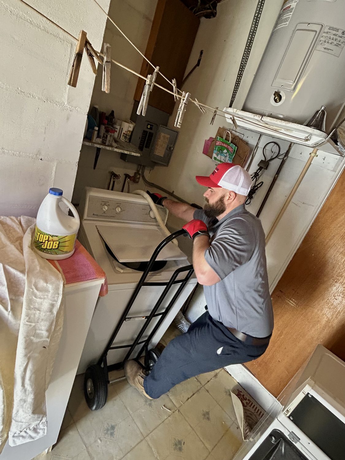 Junk Nation Removal team member removing a washer during appliance removal