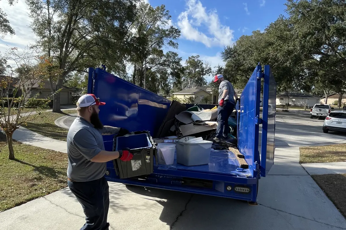 Junk Nation Removal truck being loaded during a St. Petersburg estate cleanout