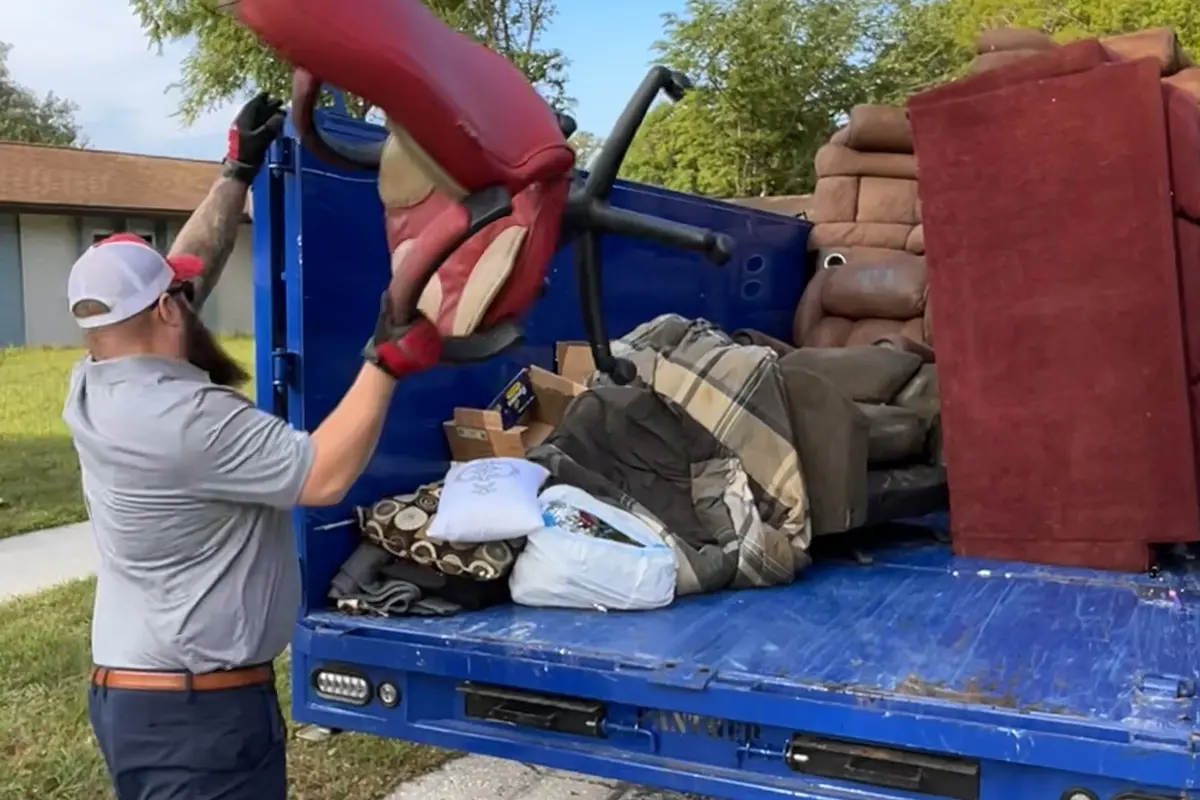 Junk Nation Removal crew loading bulky household junk into a truck for a Tampa pickup