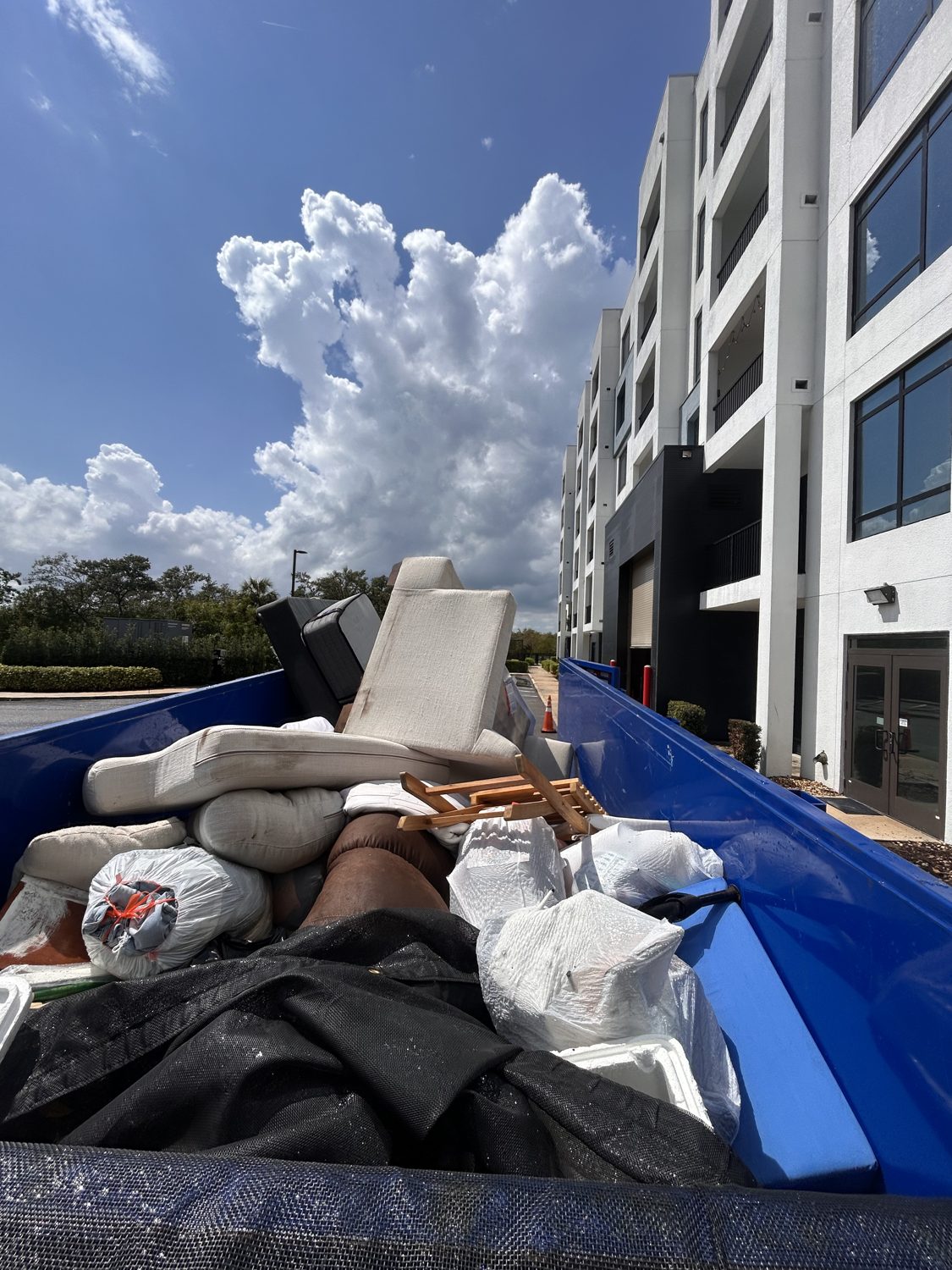 Junk Nation Removal trailer loaded with furniture at a commercial property