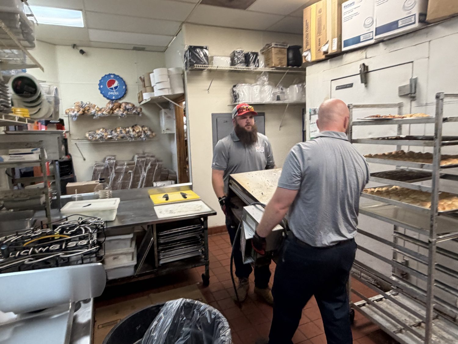 Junk Nation Removal crew removing equipment from a commercial kitchen