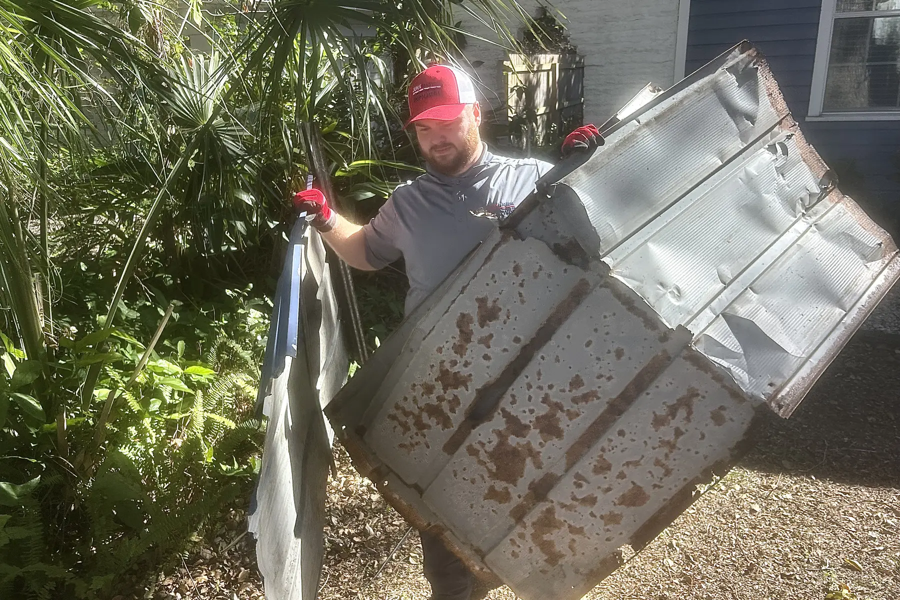 Junk Nation Removal crew removing hot tub panels in Tampa Bay