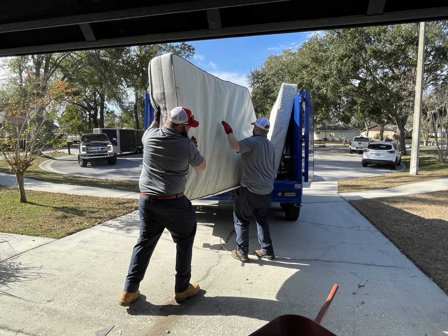 Junk Nation Removal crew loading a mattress during residential junk removal